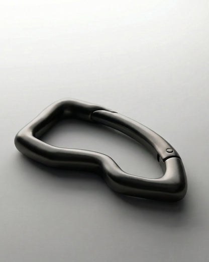 Black, abstract-shaped object on a light background.