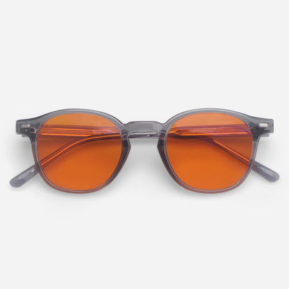 Blue light glasses with orange lenses and gray frames on a white background