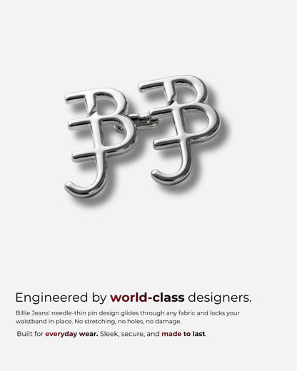 Silver pin design with interlocking letters on a plain background.