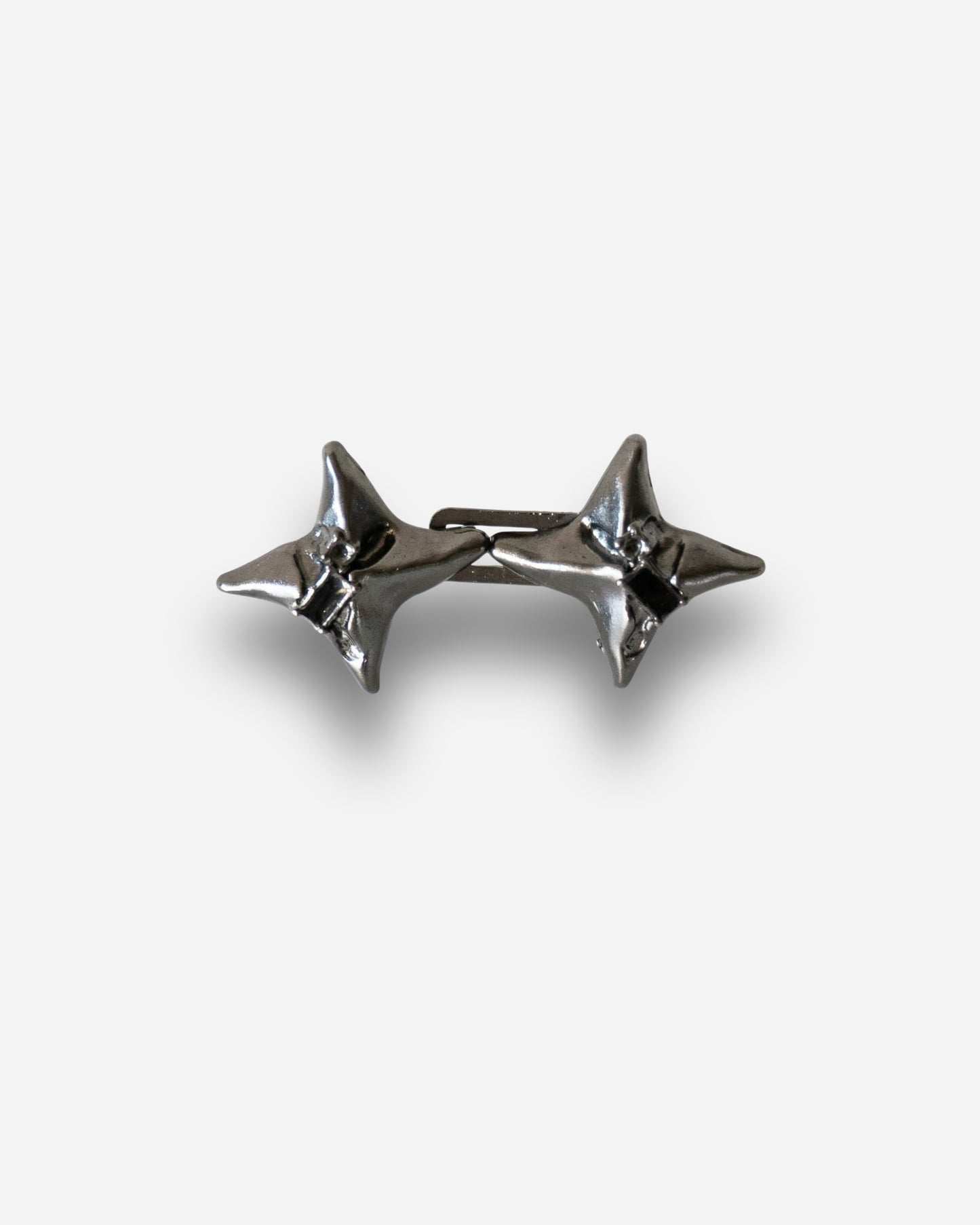Two silver star-shaped studs on a plain background