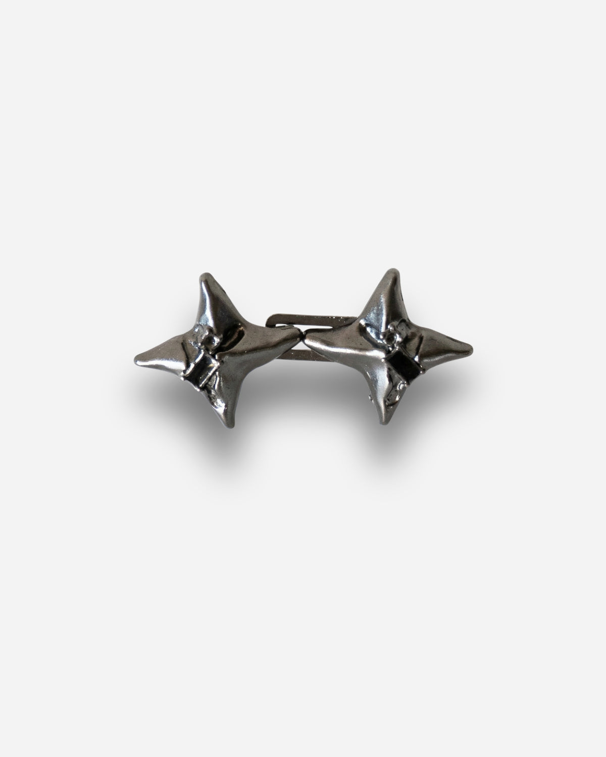 Billie Jeans Pins Nova jeans pins in gunmetal black, two spiked star pins with butterfly clasps, front view on a light background