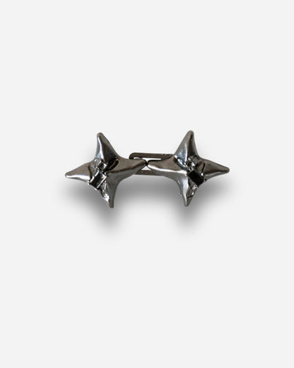 Two silver star-shaped studs on a plain background