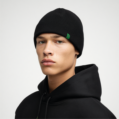 Person wearing a black beanie with a green logo on a white background