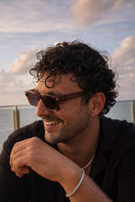 Man wearing sunglasses with a scenic background