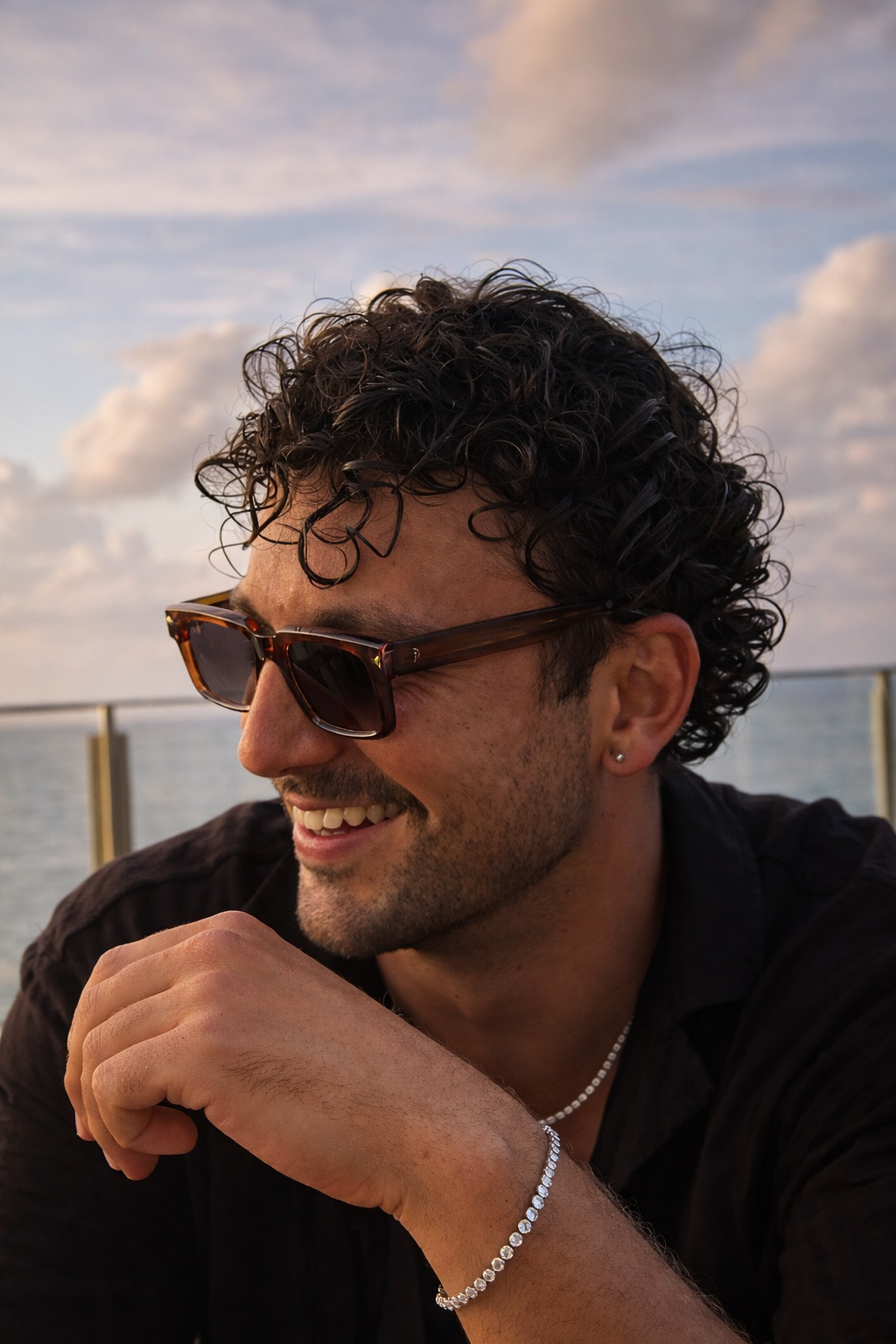 Man wearing sunglasses with a scenic background