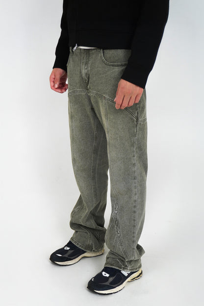 Person wearing flared jeans and black shoes on a white background