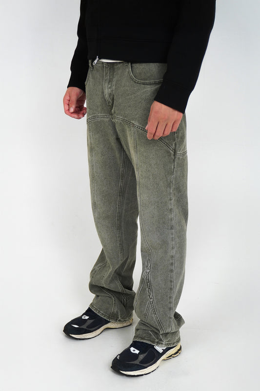 Person wearing flared jeans and black shoes on a white background