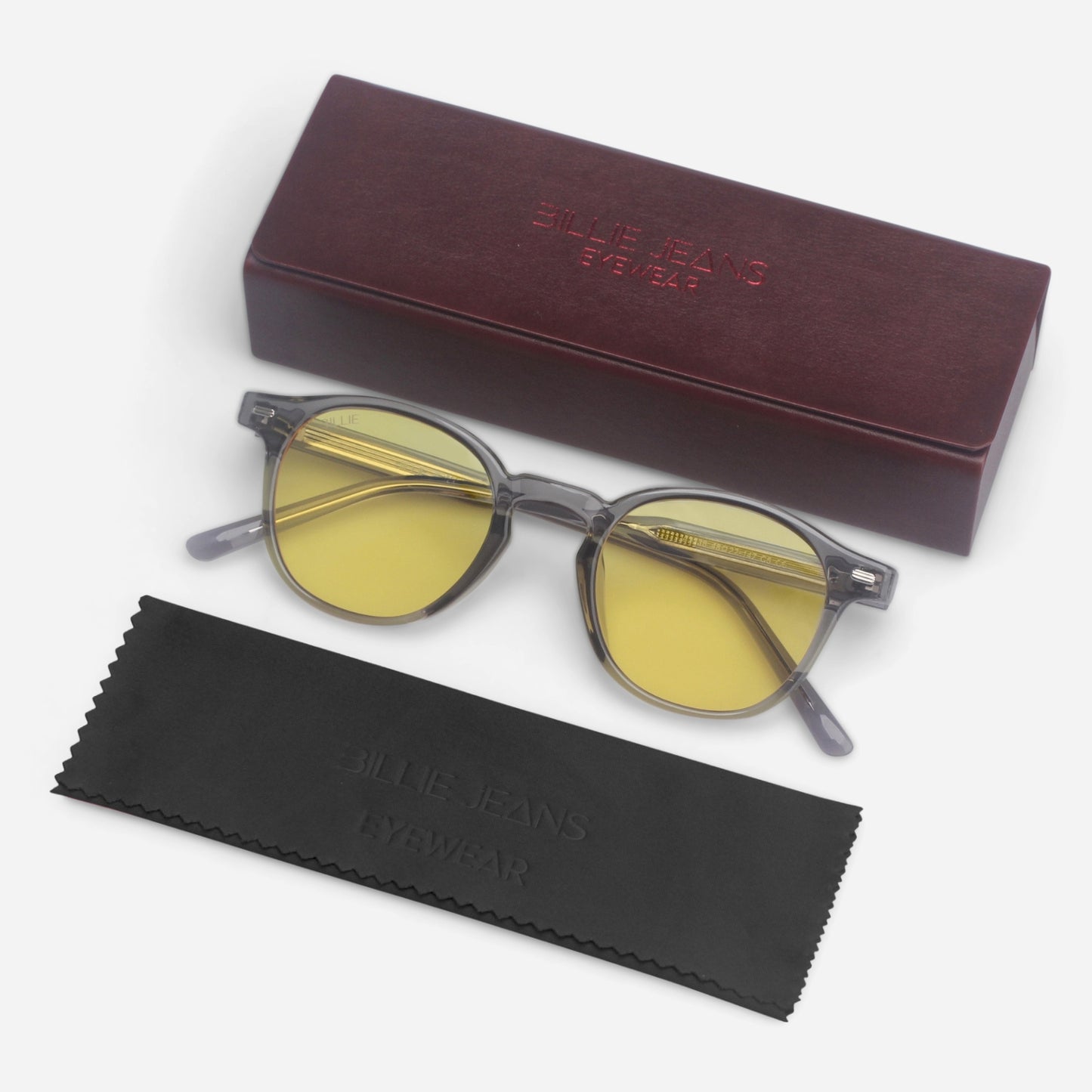 Round sunglasses with yellow lenses and a maroon case on a white background