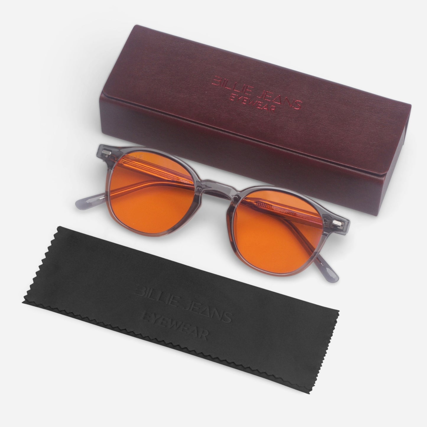 Round sunglasses with orange lenses and a dark brown case on a white background