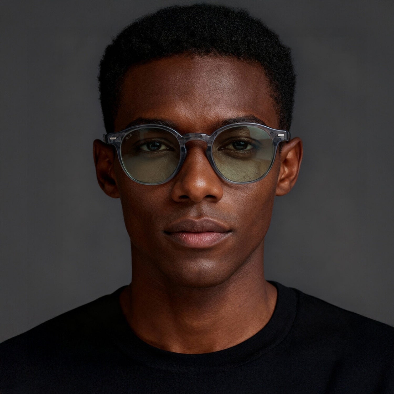 Man wearing glasses with a dark background