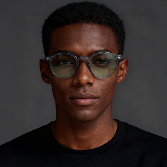 Man wearing glasses with a dark background