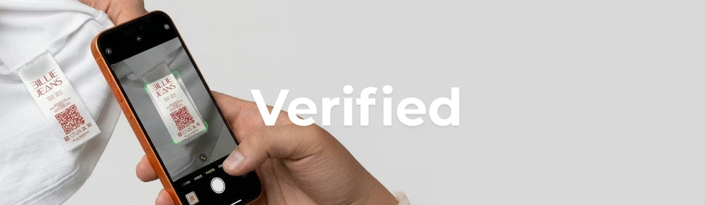 Hand holding a smartphone with a QR code scanner app, scanning a QR code on a label. The word 'Verified' is displayed.