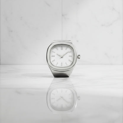 Silver ring watch with a white face on a light gray background