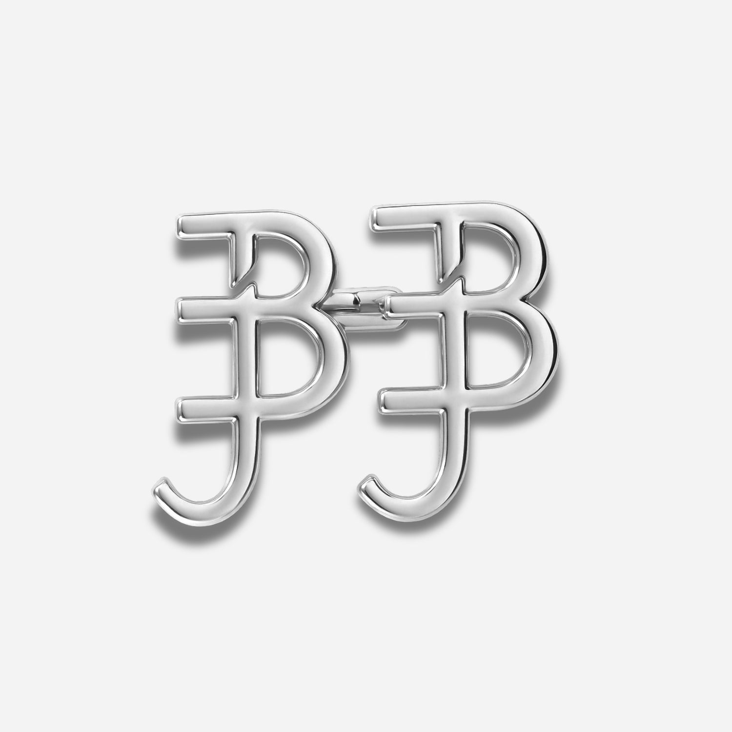Silver letter 'BJ' brooch on a light gray background