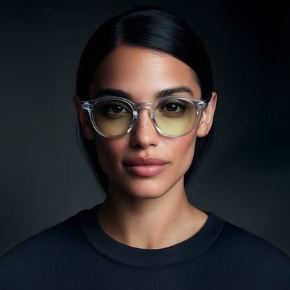 Person wearing glasses with a dark background