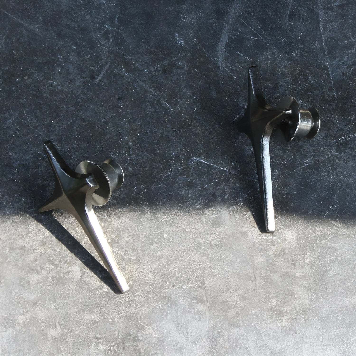 Two metal objects on a textured surface