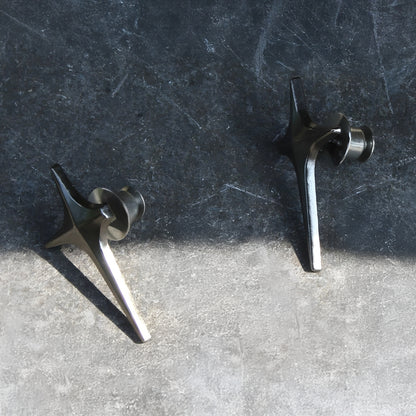 Two metal objects on a textured surface