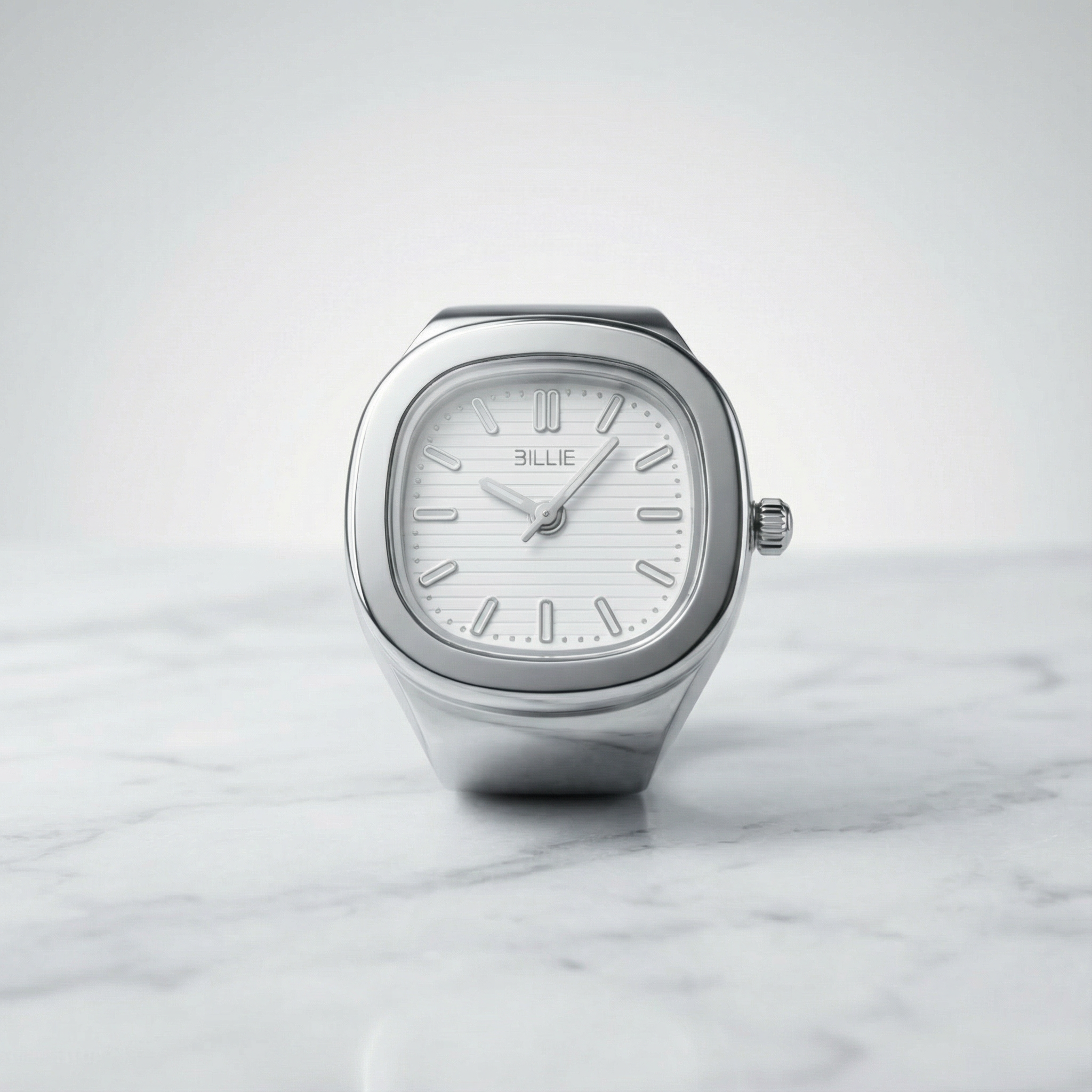 Silver watch with a white face on a marble surface