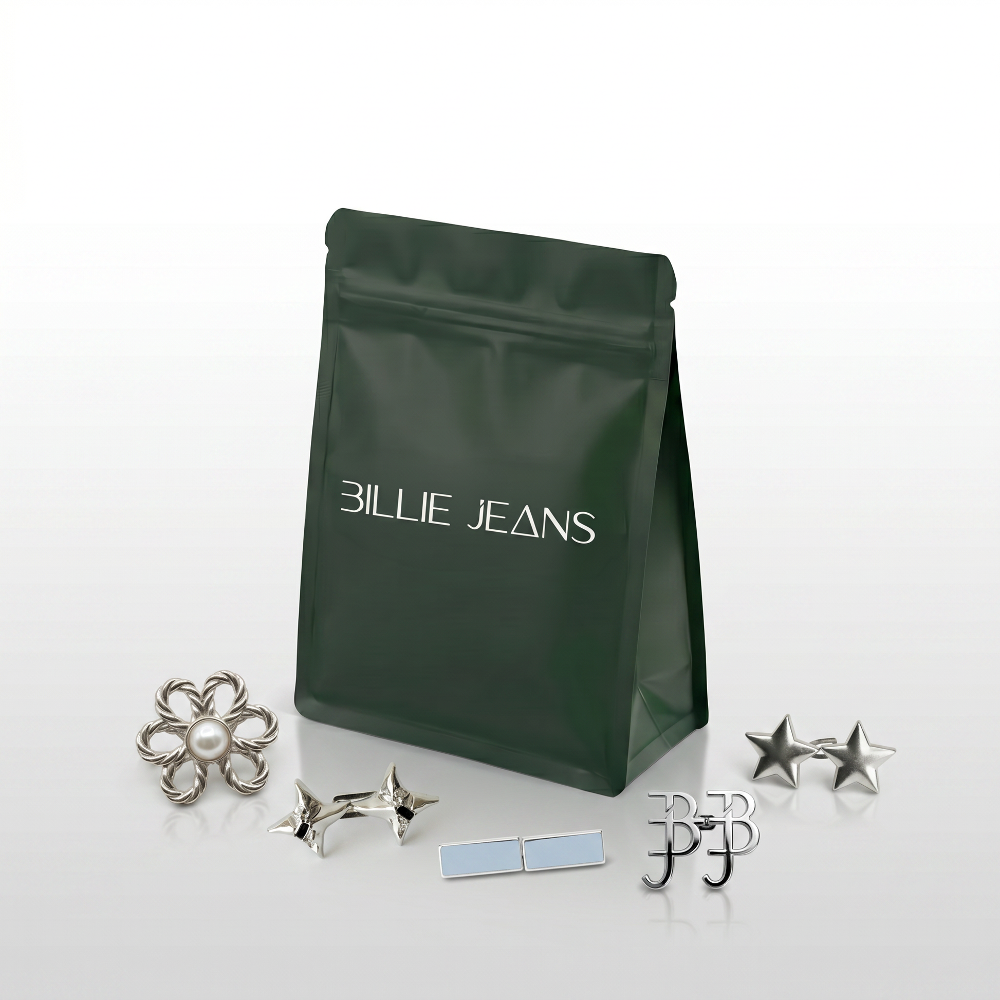 Billie Jeans dark green branded pouch with a collection of silver jeans pins including flower pearl, star, BJ monogram and rectangle designs