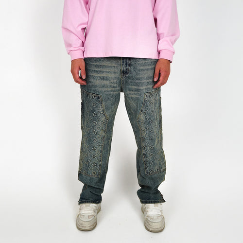 Person wearing a pink sweatshirt and blue jeans on a white background