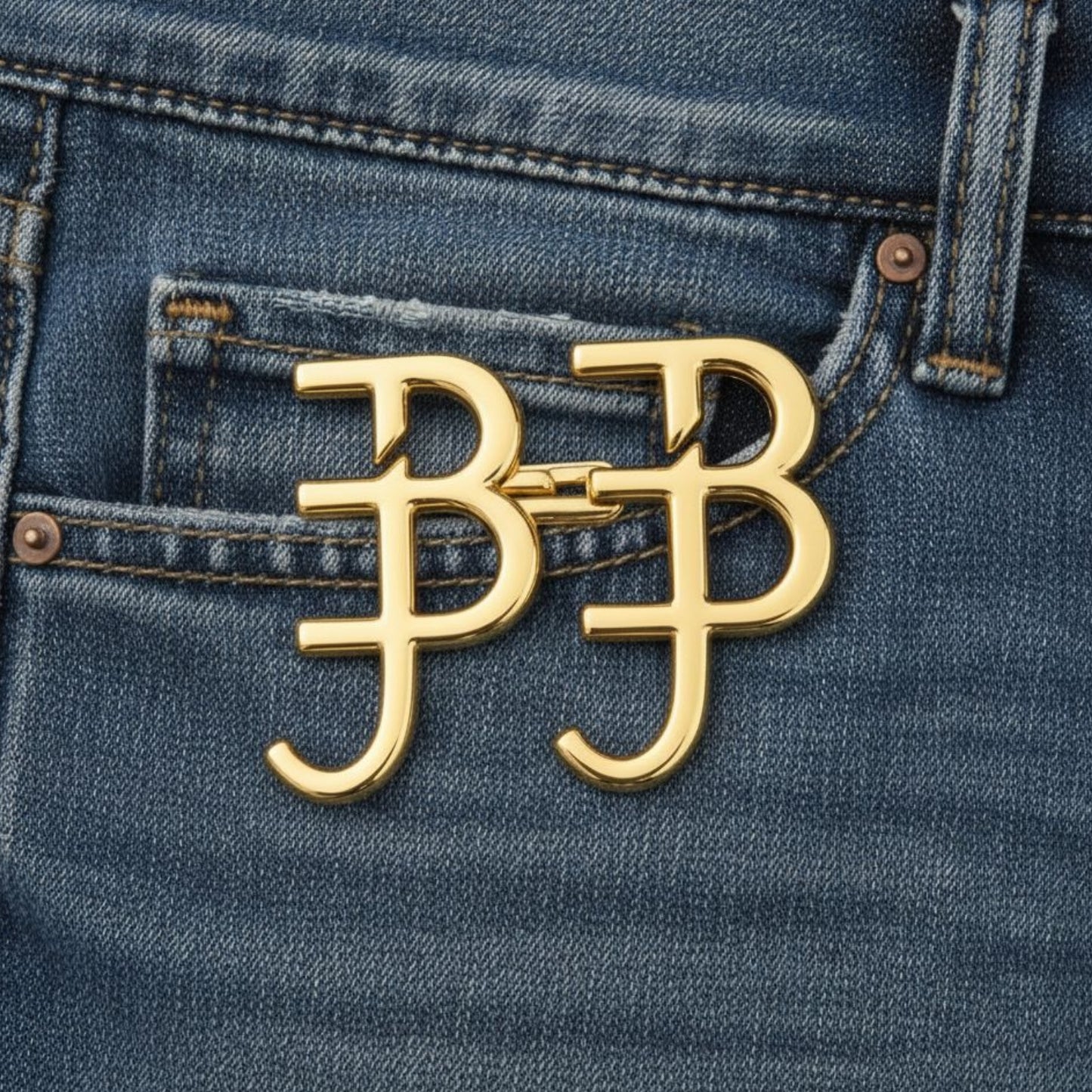 Gold 'BB' logo on a blue denim background